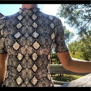Snakeskin short sleeve turtle neck. Sz x-small.